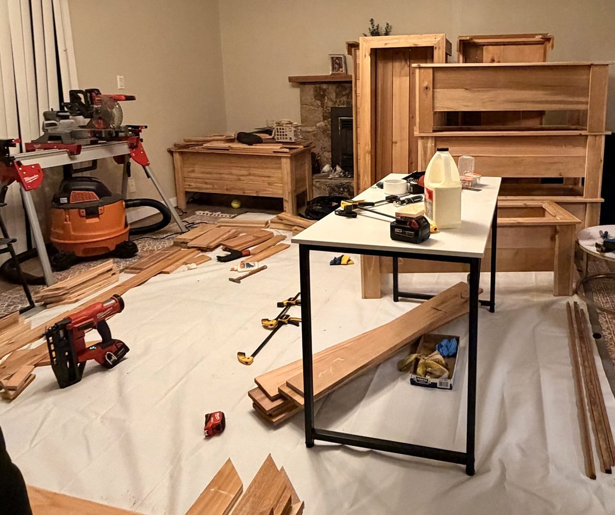 Cedar boards and tools used for custom planter construction in the workshop
