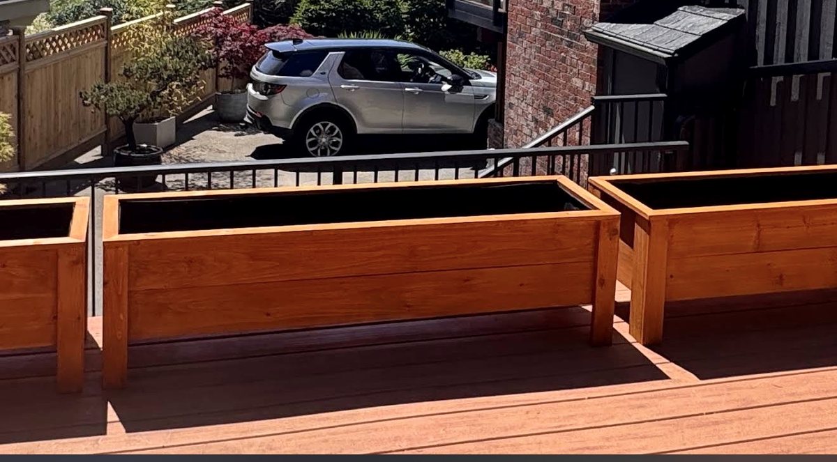 Finished cedar planters installed on a deck railing in West Vancouver