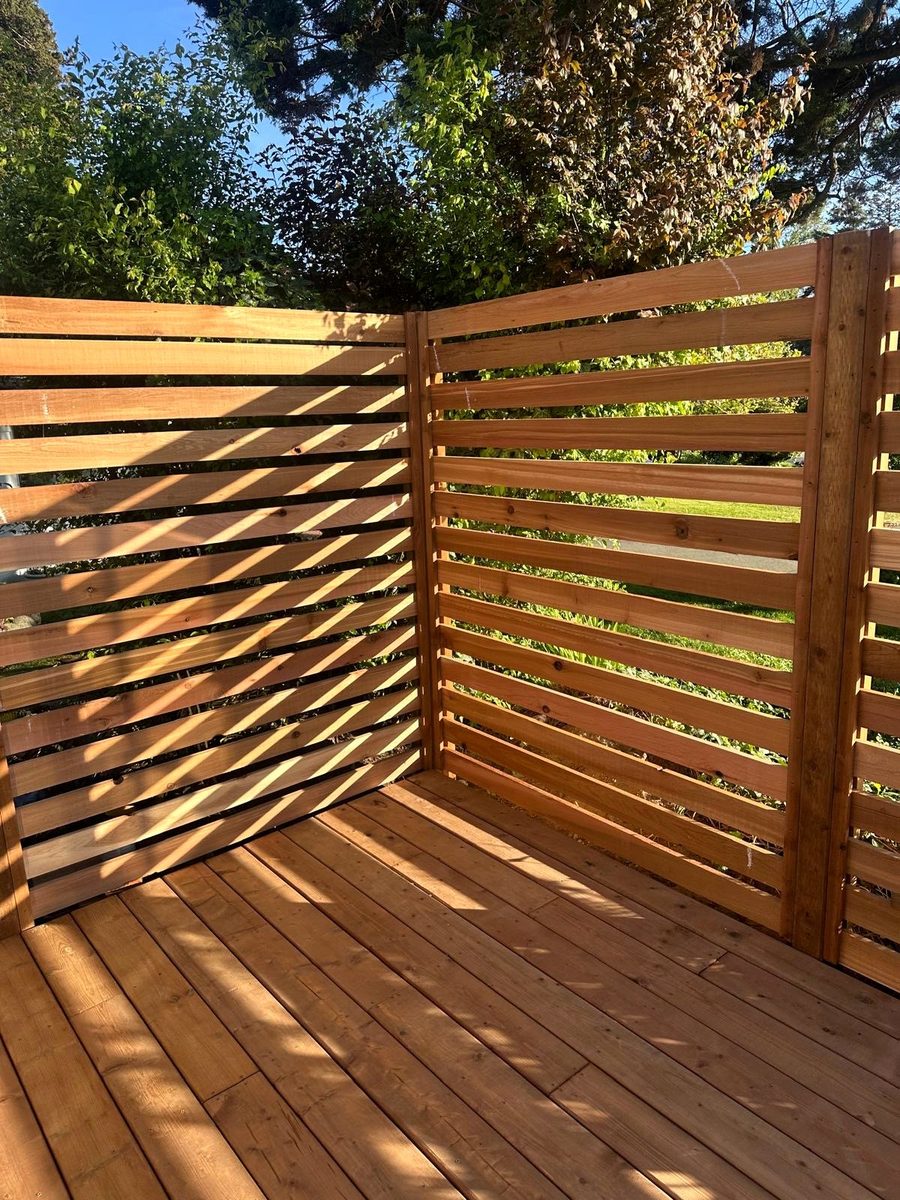 Hand-built cedar slat privacy screen installed on a backyard deck in Vancouver